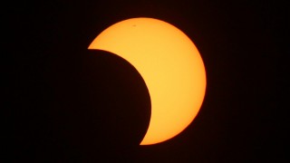 Partially eclipse with moon and sun