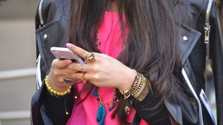 A woman looks at her cell phone