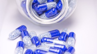 Weight loss supplements blue and white pills with bottle