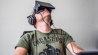 A man wears the virtual reality headset the Oculus Rift