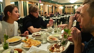 A family has a serious discussion around the dinner table