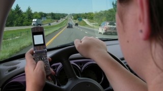 A woman is texting and driving