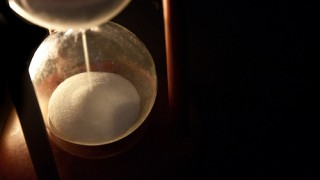 Sand running out through an hourglass