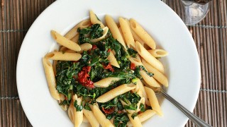 Vegan pasta with green vegetables on top