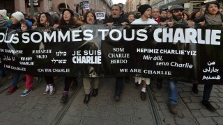 Paris march for Charlie Hebdo people carry a sign saying "we are all Charlie" and various translations of the phrase "I am Charlie"