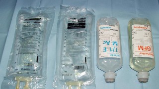 Four bags of IV saline solution.
