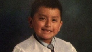 6 year old Mikey died of the flu and is pictured here in a graduation gown