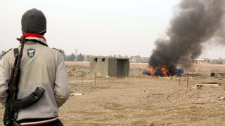 Pictured Jan 2nd, insurgents burn a police vehicle