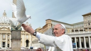 Undate photo of Pope Francis welcoming a peace dove