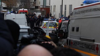 Police surround a newspaper building in Paris following a terror attack on Jan. 7