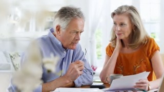 Stock photo couple reviewing bills