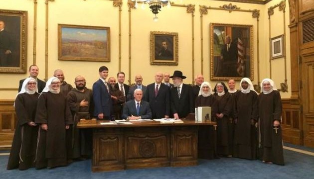 Mike Pence with a bunch of religious leaders signing the RFRA