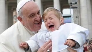 Pope Francis holding a screaming baby