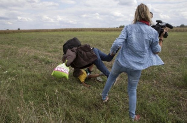 Laszlo trips an older man, holding a small child.