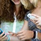 Teen girls use cell phones